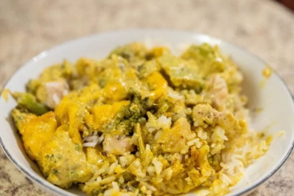 A plate of chicken and broccoli curry casserole served over rice.