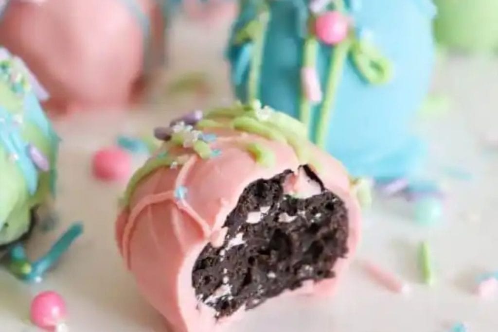 Spring desserts: Colorful cake pops with a bitten one revealing an Oreo cookie center.